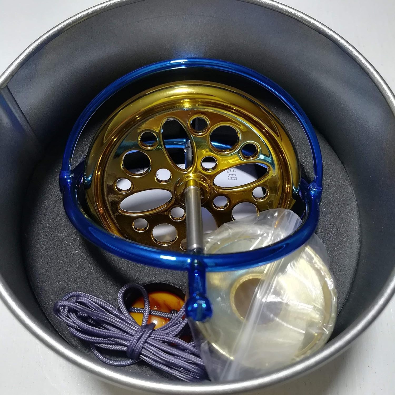 Mystic Anti-Gravity Spinning Top — polished metal precision gyroscope spinning in motion over a tabletop pedestal