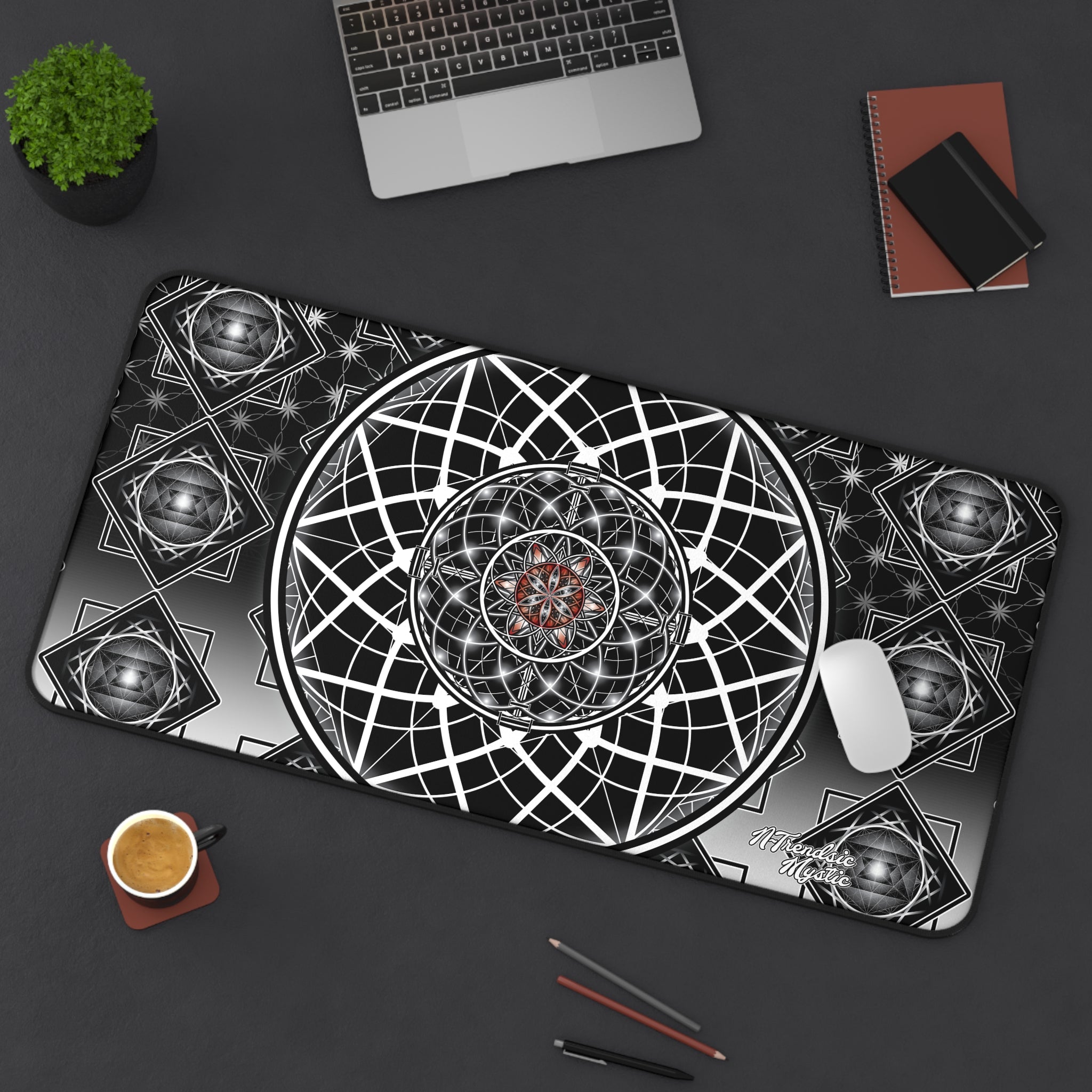 Decorative mouse pad with geometric design on a dark surface with office items.