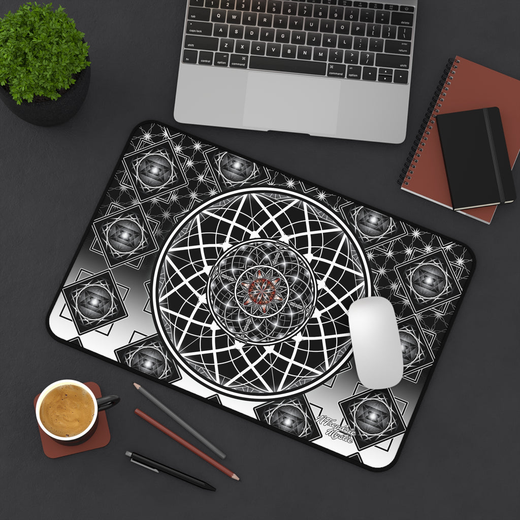 Mouse pad with geometric design on a desk with laptop, notebook, and coffee.