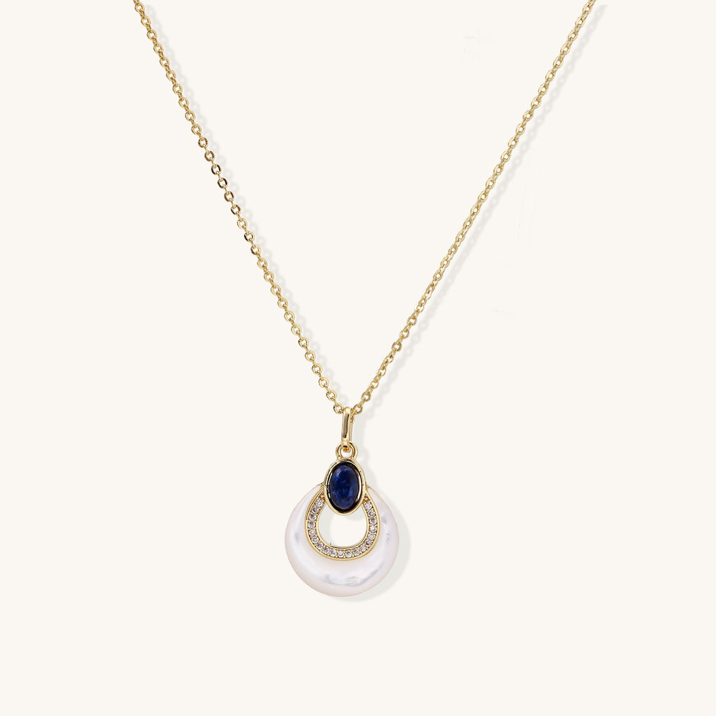 Layered pendant necklace with deep blue lapis lazuli stone, crystals, and white mother of pearl on 18k gold plated chain