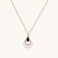 Layered pendant necklace with deep blue lapis lazuli stone, crystals, and white mother of pearl on 18k gold plated chain