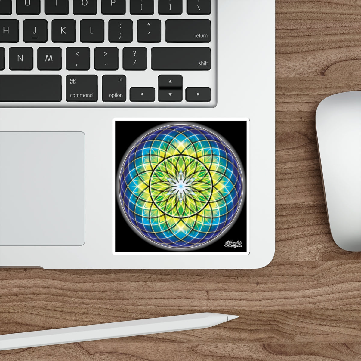 Laptop with a mandala sticker on a wooden desk