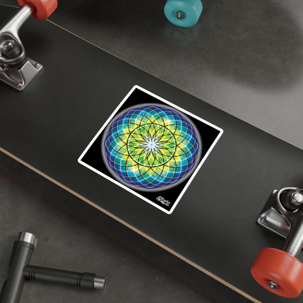 Colorful geometric design on a skateboard deck with visible trucks and wheels.