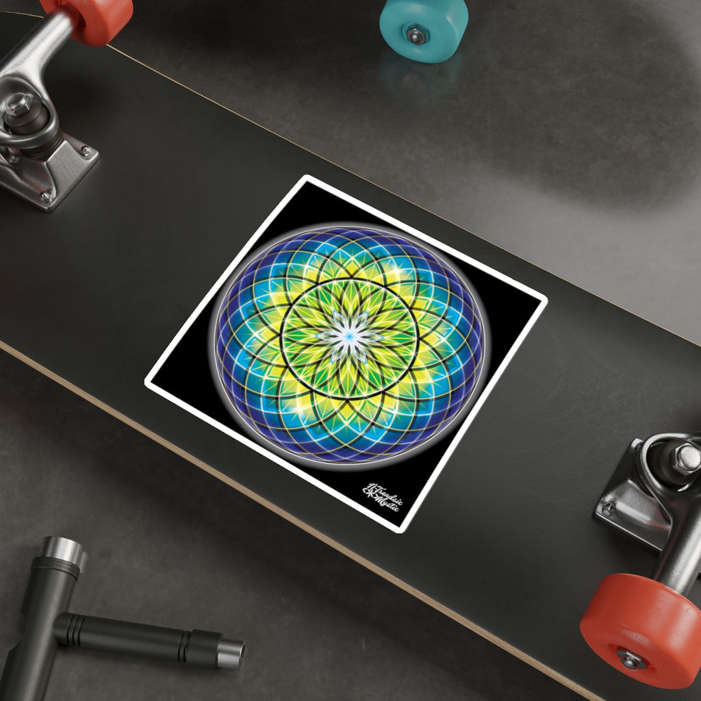 Colorful geometric design on a skateboard deck with visible trucks and wheels.