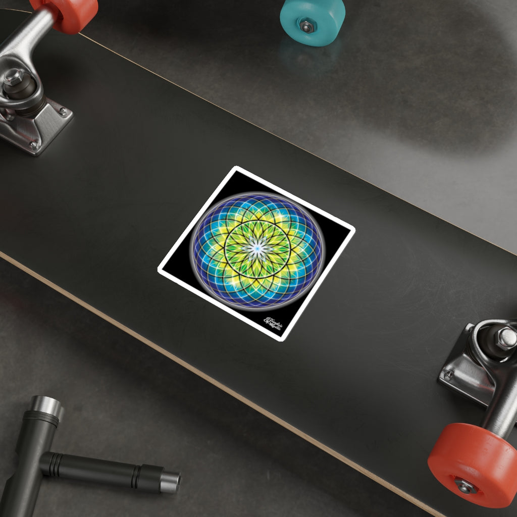 Colorful mandala sticker on a skateboard deck with visible trucks and wheels.