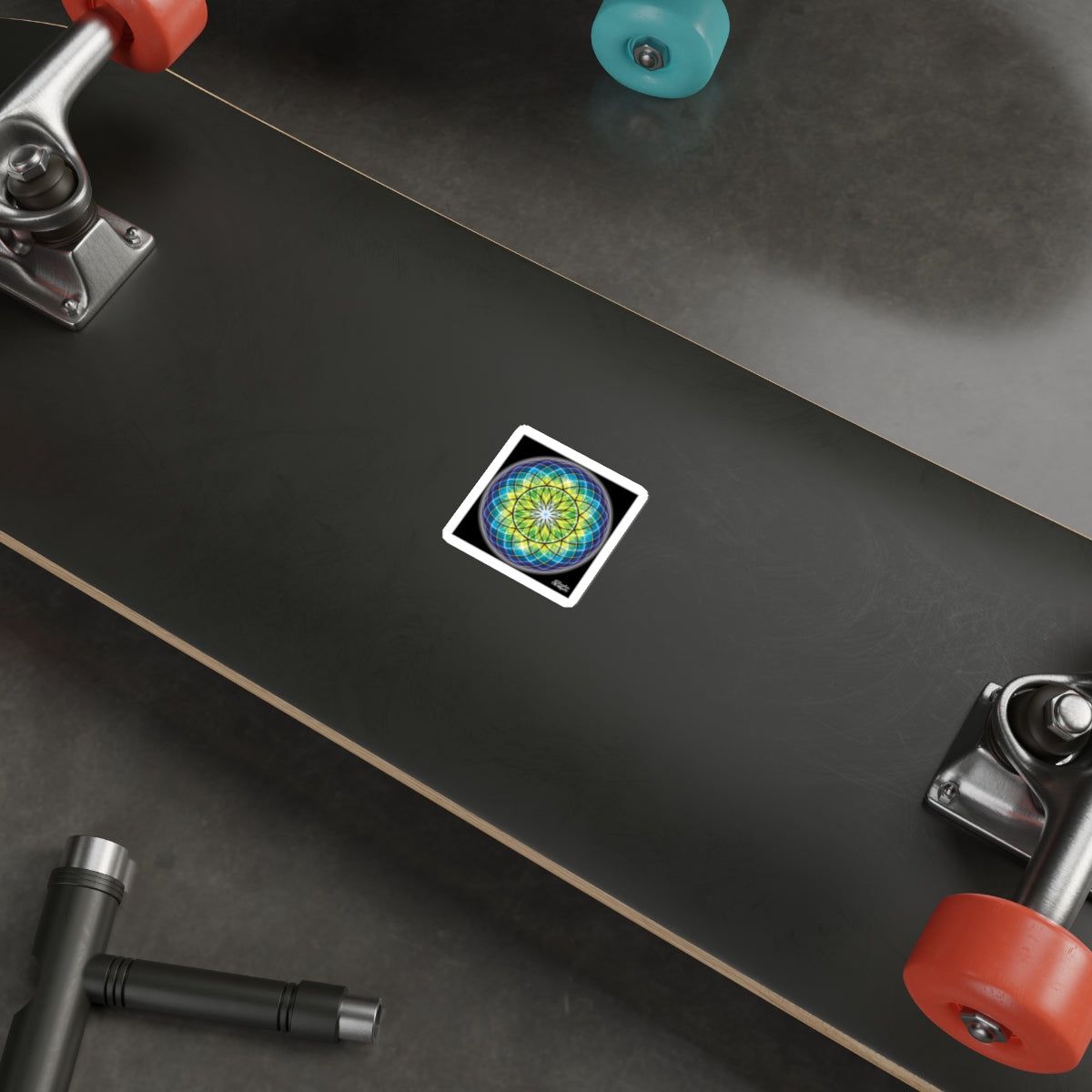Skateboard with a colorful sticker on a black surface