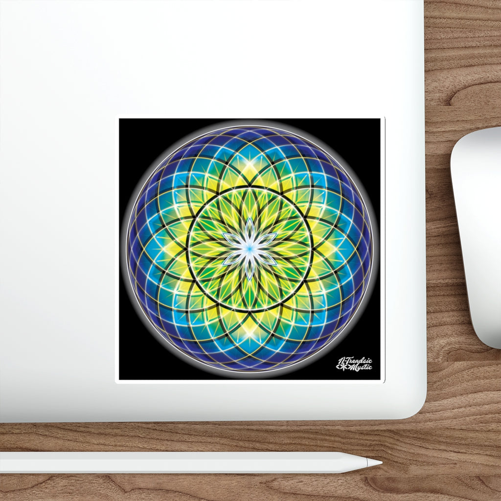 Colorful mandala design on a laptop screen with a white mouse and pen on a wooden surface.