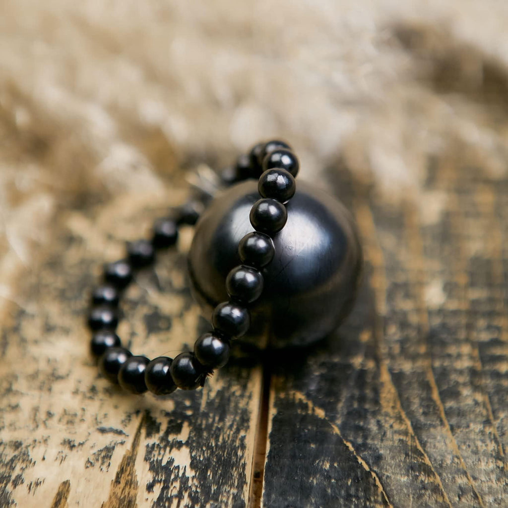 Mystic Shungite set — two stretch bracelets and a polished sphere (30 mm or 50 mm), crafted from authentic Shungite for contemplative adornment