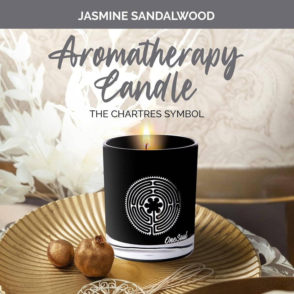Luxury soy aromatherapy candle in black glass with sacred symbol design, available in multiple earthy and floral scents.