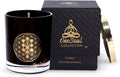 Luxury soy aromatherapy candle in black glass with sacred symbol design, available in multiple earthy and floral scents.