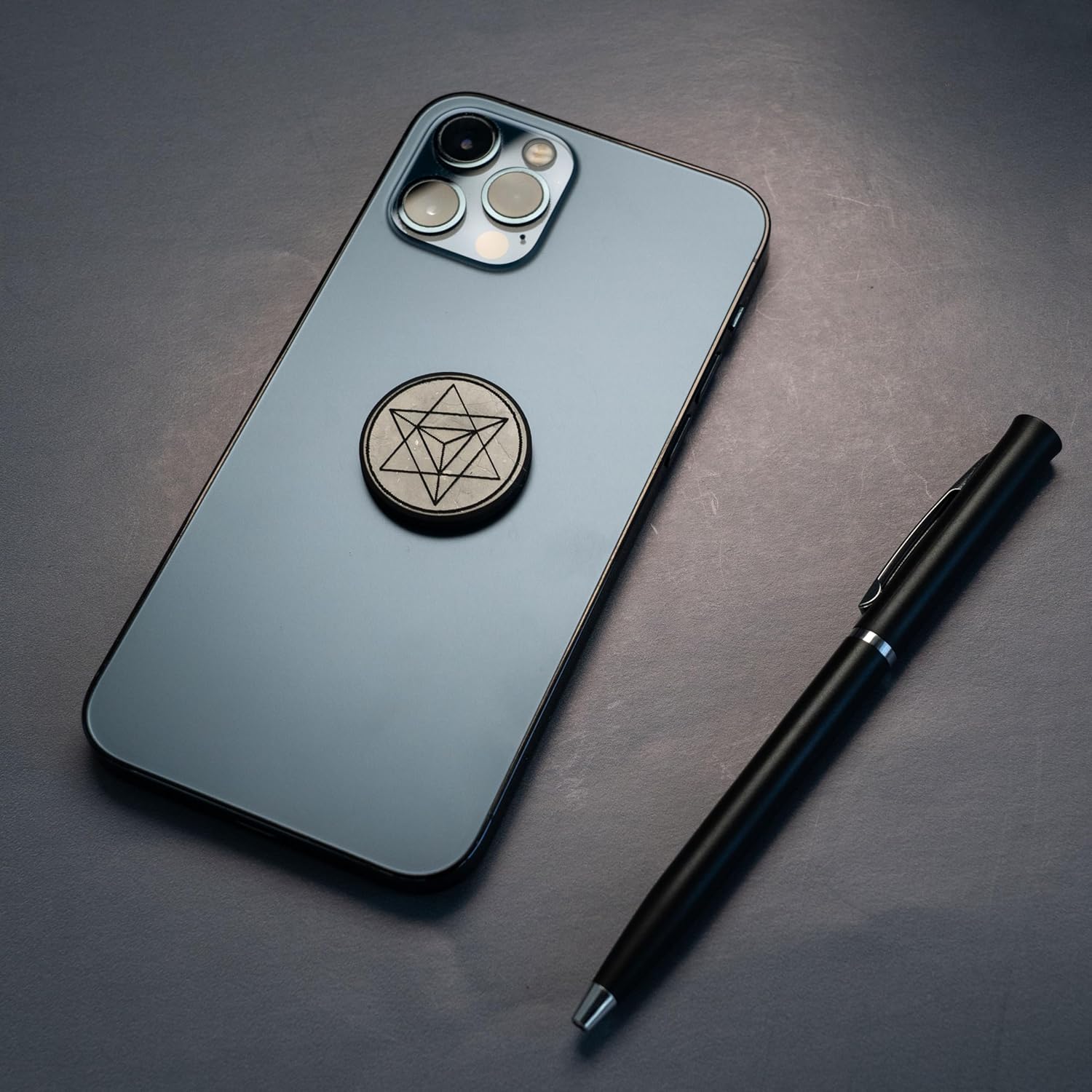 Shungite round phone sticker — polished stone with sacred geometry engravings (Merkaba, Metatron’s Cube, Flower of Life) or plain polished finish