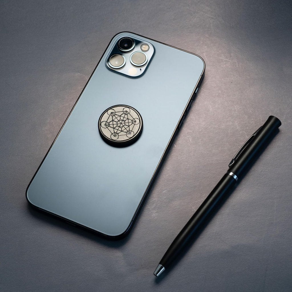 Shungite round phone sticker — polished stone with sacred geometry engravings (Merkaba, Metatron’s Cube, Flower of Life) or plain polished finish