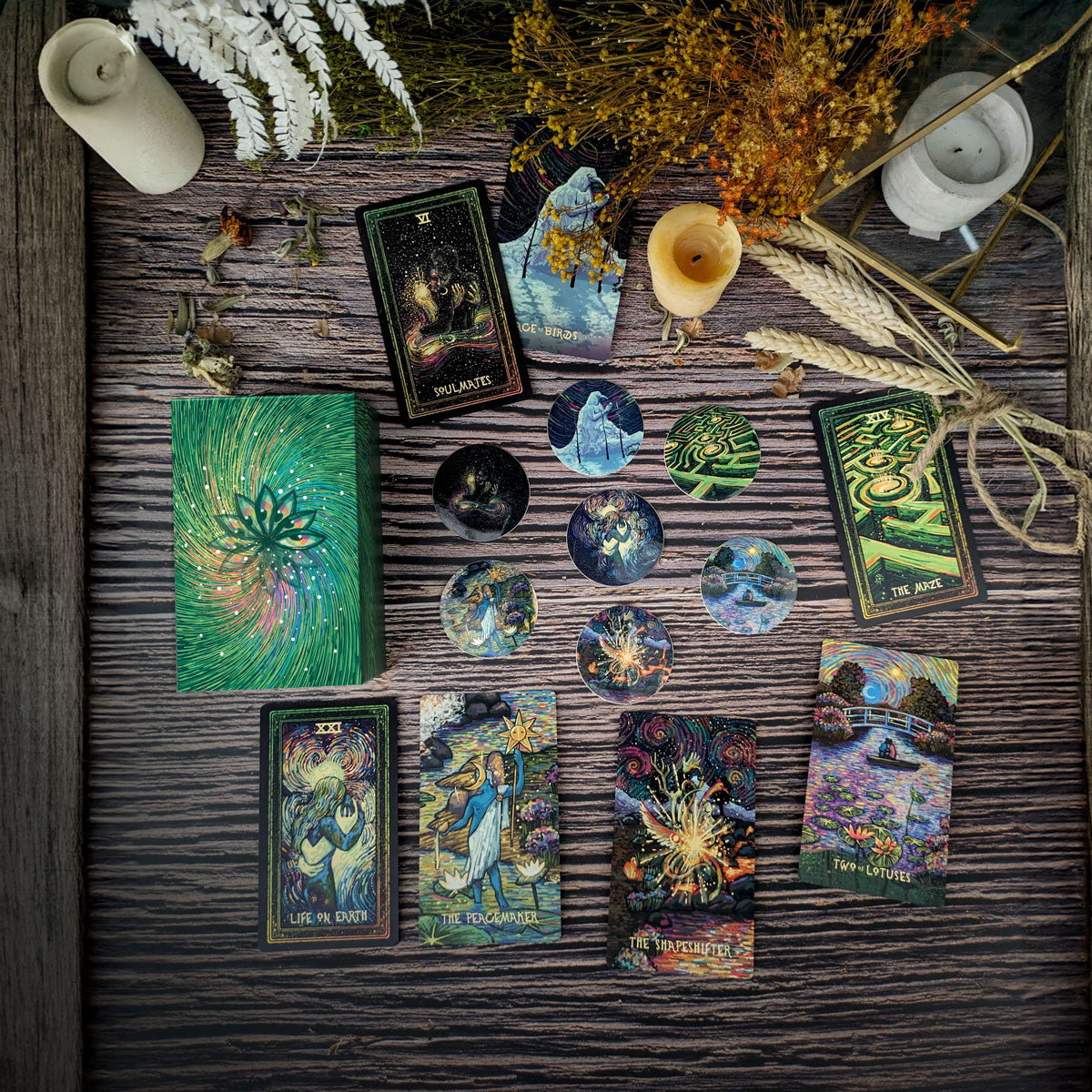 Collection of tarot cards and decorative items on a wooden surface