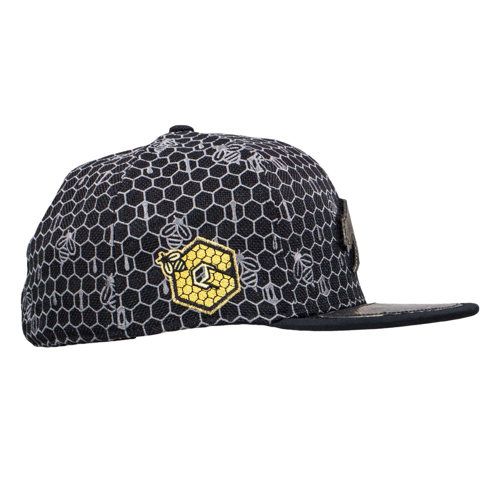 Black and gray honeycomb pattern cap with yellow logo on a white background