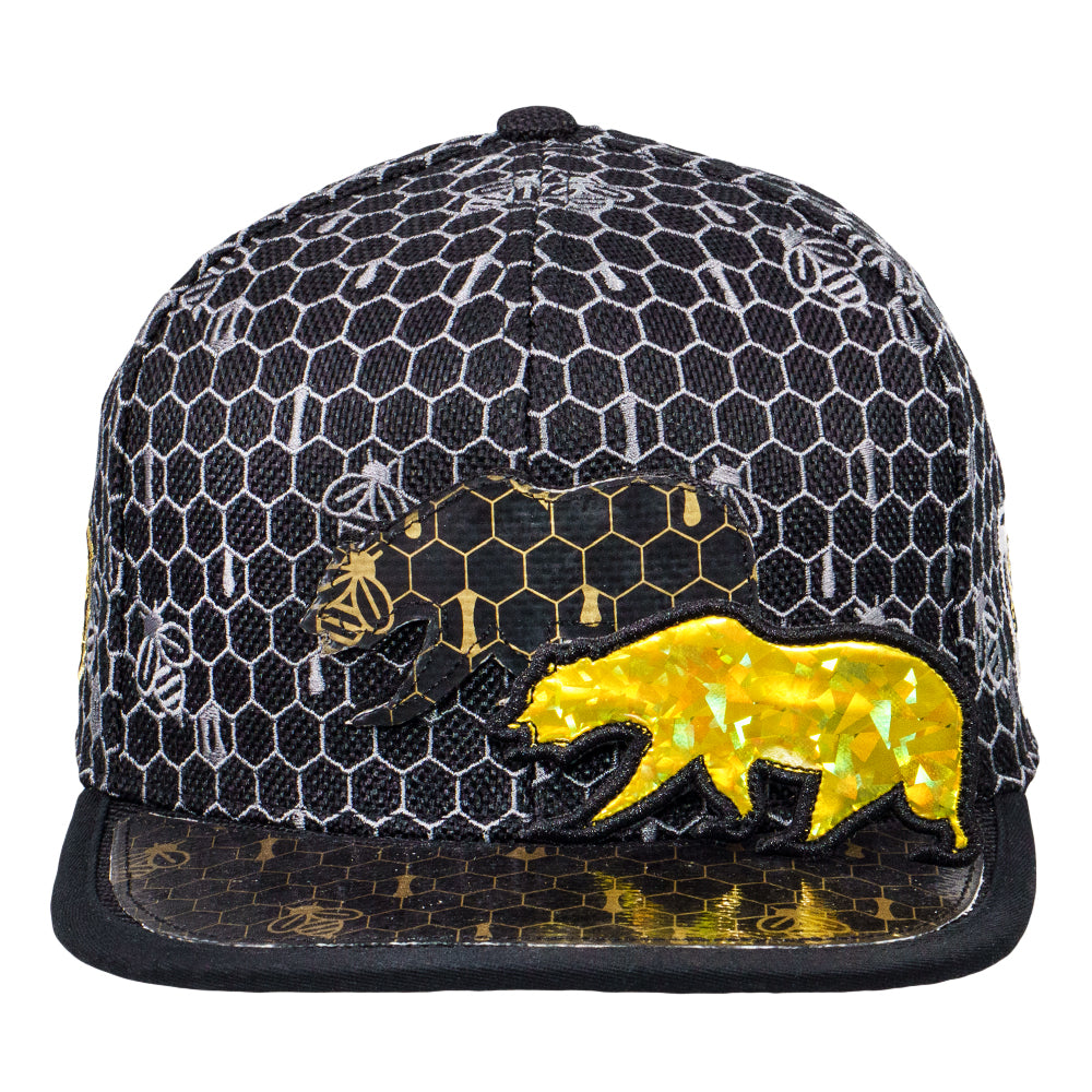 Cap with honeycomb pattern and bear design on a white background