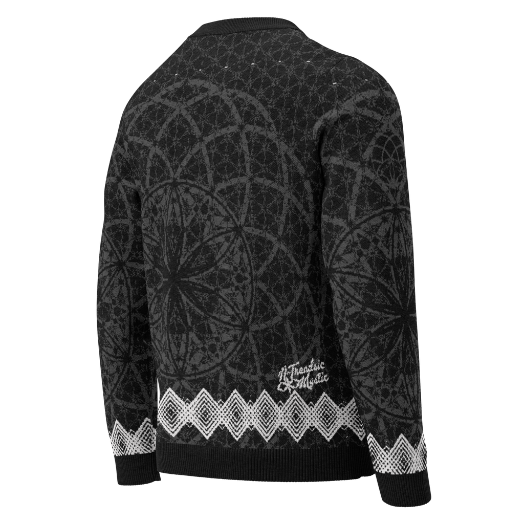 Black knitted sweater with all-over sacred geometry pattern, white diamond trim at hem and cuffs, and NTrendSic Mystic branding on back hem.