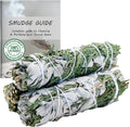 Three white sage and cedar smudge sticks bundled together for ritual cleansing and spiritual grounding