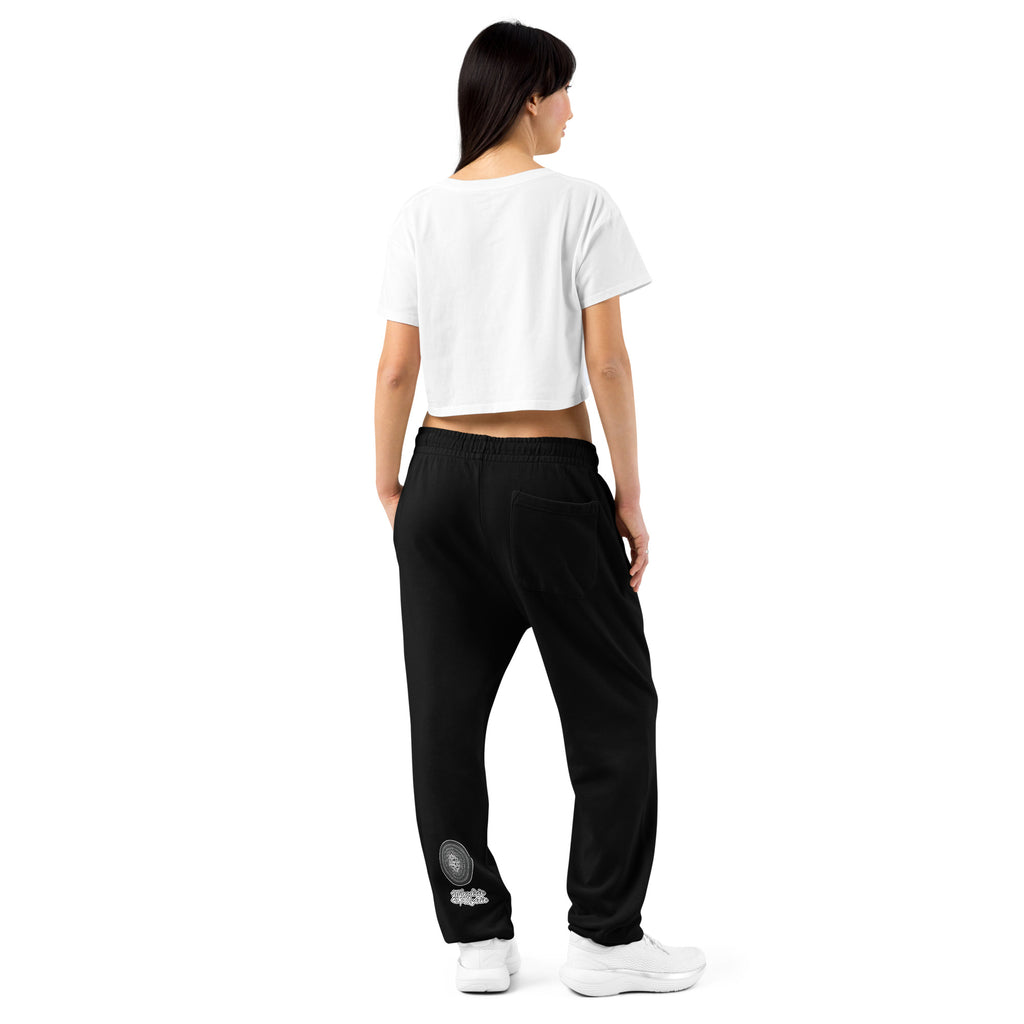 Model wearing black NTrendSic Keystone urban sweatpants made from heavyweight fleece with relaxed fit, elastic cuffs, zippered pockets, and minimalist streetwear design. Product mockup