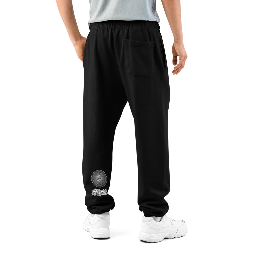 Model wearing black NTrendSic Keystone urban sweatpants made from heavyweight fleece with relaxed fit, elastic cuffs, zippered pockets, and minimalist streetwear design. Product mockup