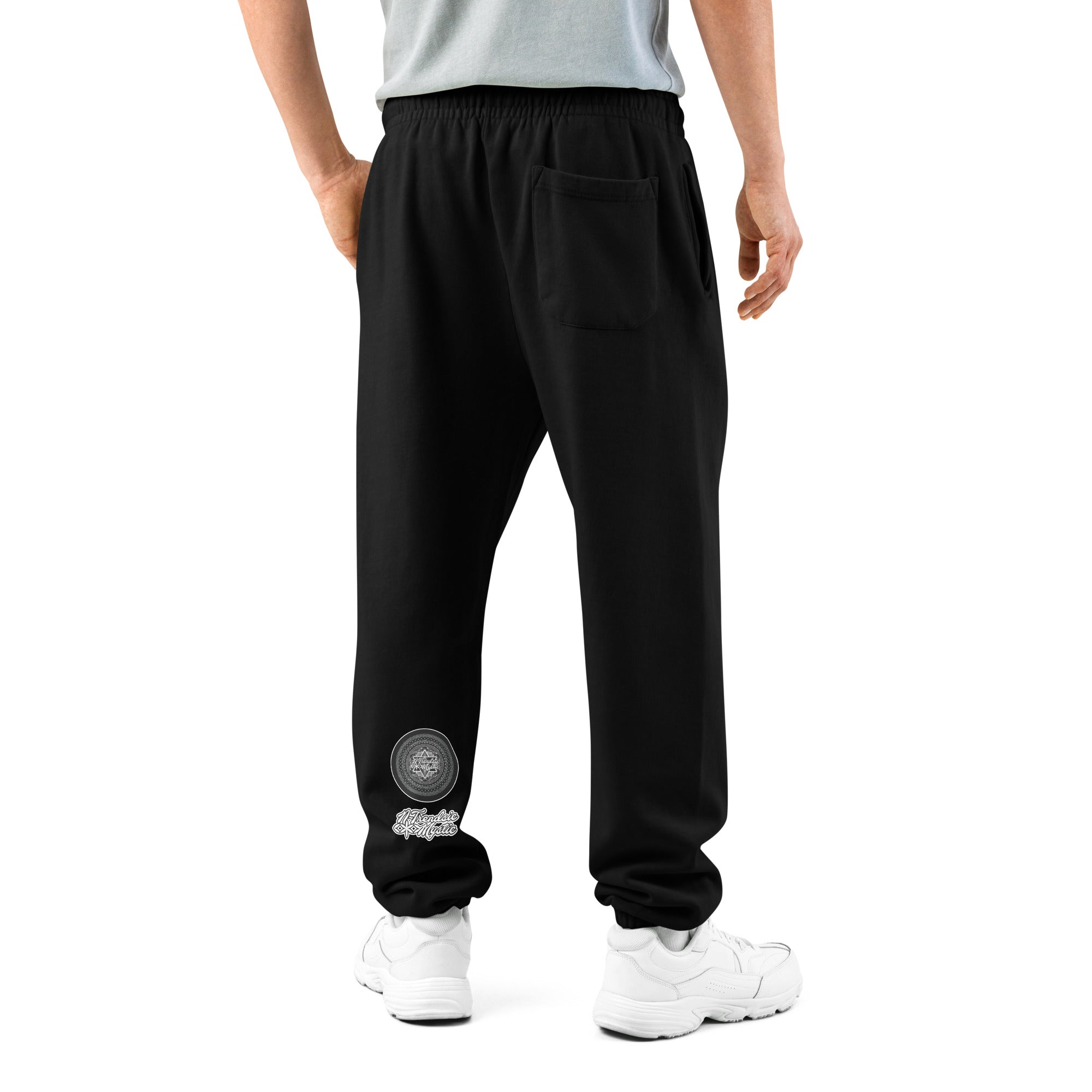 Model wearing black NTrendSic Keystone urban sweatpants made from heavyweight fleece with relaxed fit, elastic cuffs, zippered pockets, and minimalist streetwear design. Product mockup