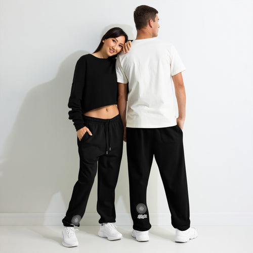 Model wearing black NTrendSic Keystone urban sweatpants made from heavyweight fleece with relaxed fit, elastic cuffs, zippered pockets, and minimalist streetwear design. Product mockup
