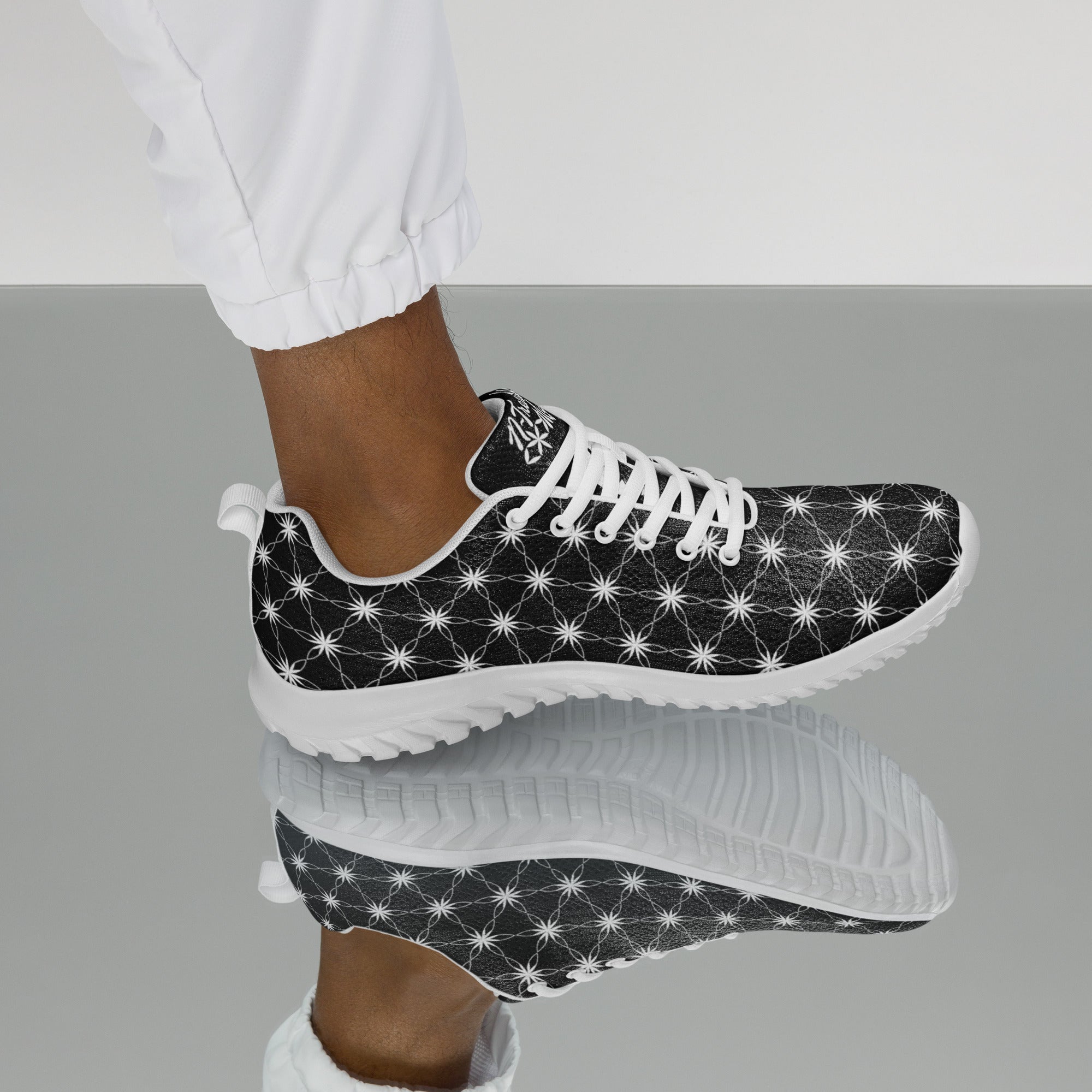 Men’s athletic shoes with all-over black-and-white Flower of Life pattern, white sole, and NTrendSic Mystic branding.