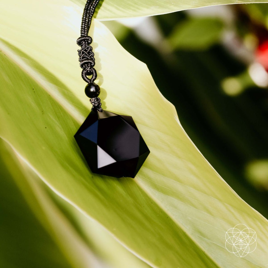 Hexagram pendant detail showcasing volcanic glass texture.