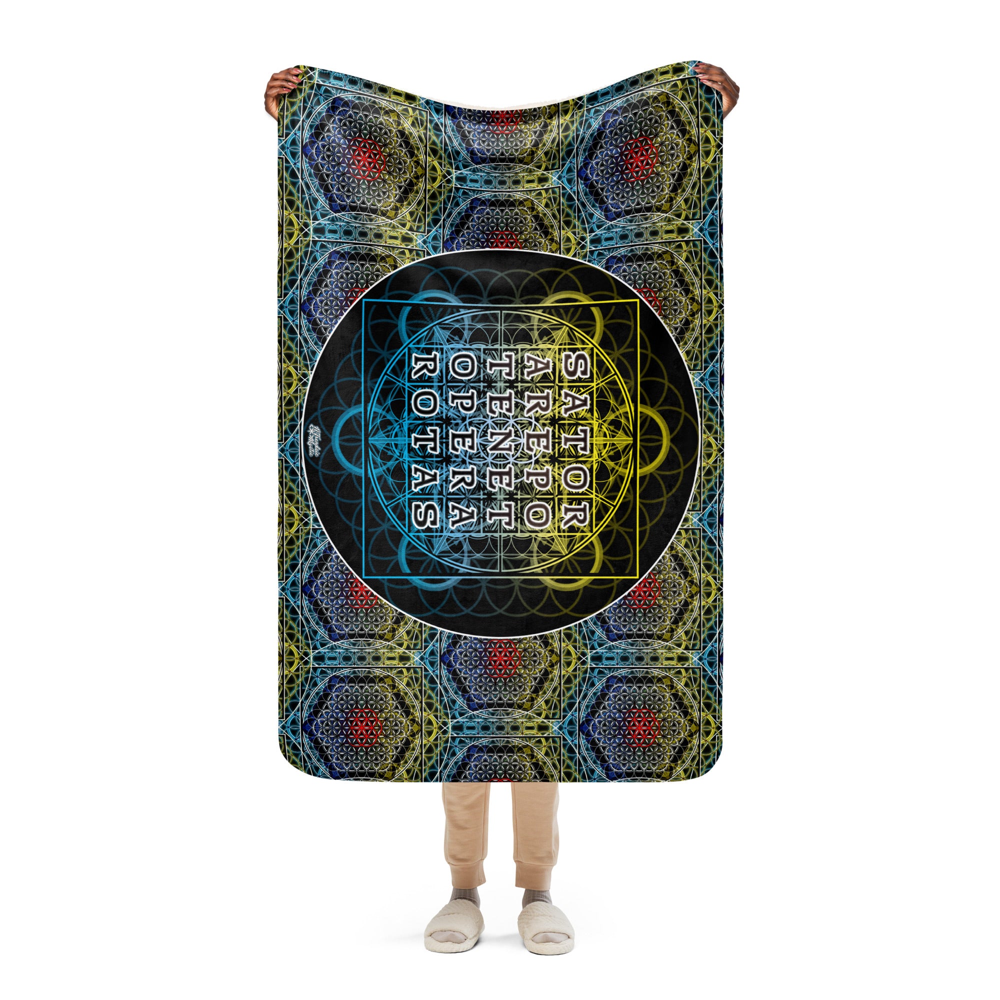 Person holding a colorful blanket with geometric patterns and text on a white background