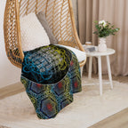 Sherpa blanket draped on sofa, displaying the SATOR Square design and multicolor geometric pattern.