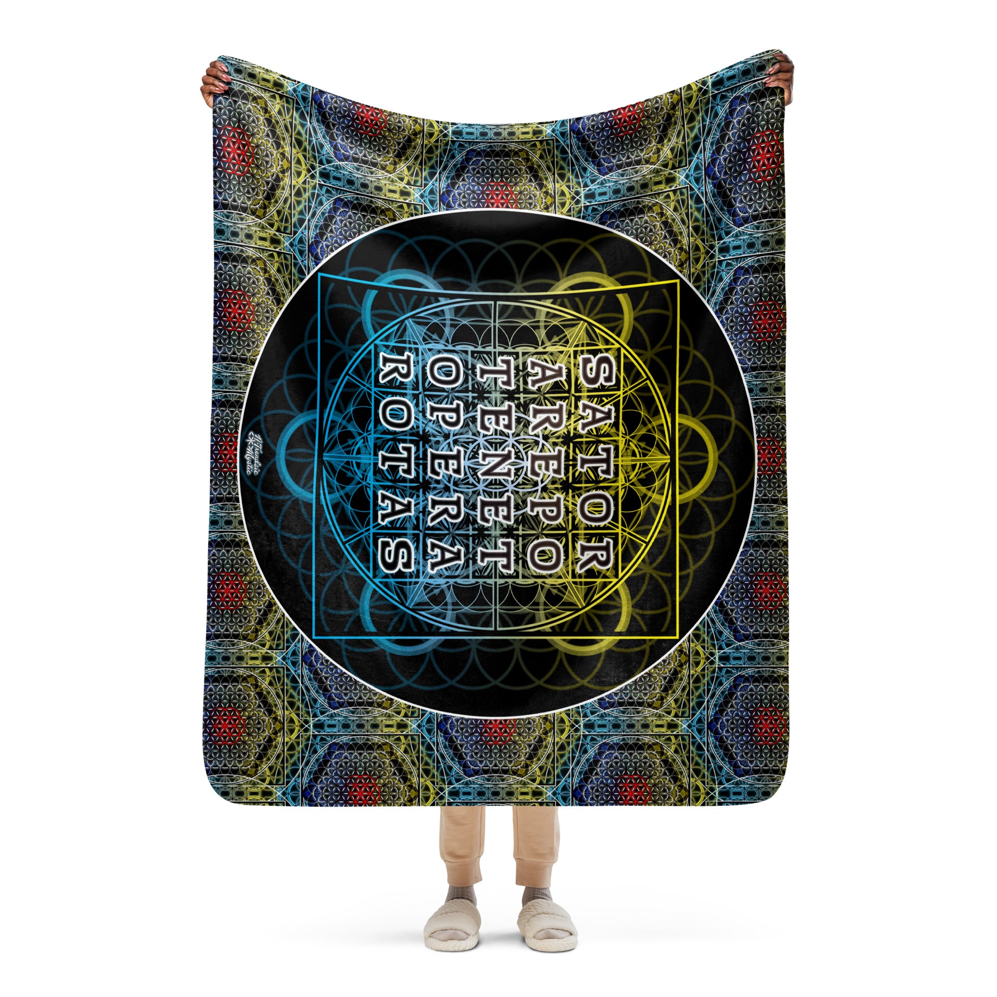 Model holding large sherpa blanket with detailed sacred geometry grid and SATOR text at the center.
