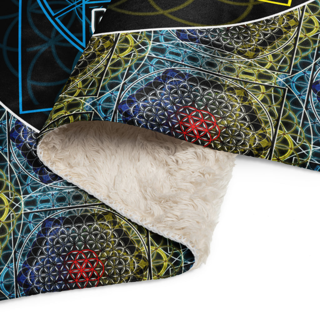 Close-up of a textured fabric with geometric patterns and a rolled-up beige fabric on a white background.