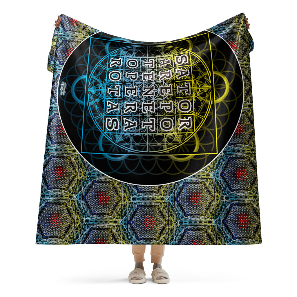 Model holding large sherpa blanket with detailed sacred geometry grid and SATOR text at the center.