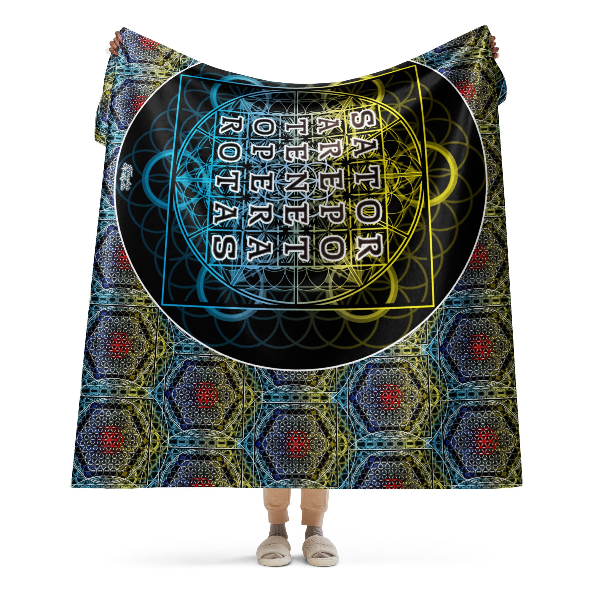 Model holding large sherpa blanket with detailed sacred geometry grid and SATOR text at the center.
